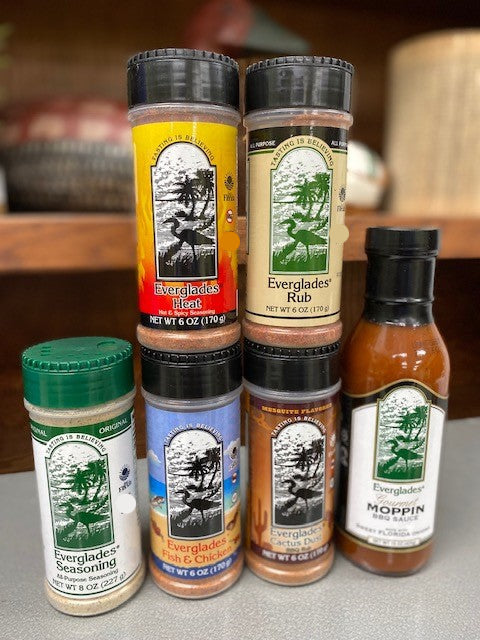A collection of Everglades brand seasonings and sauces, including bottles and shakers of spices.
